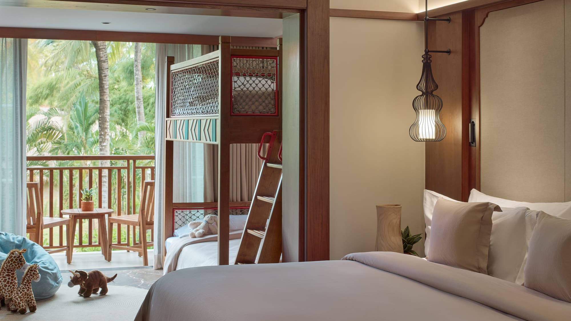 a room with a bed and bunk beds