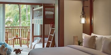 a room with a bed and bunk beds