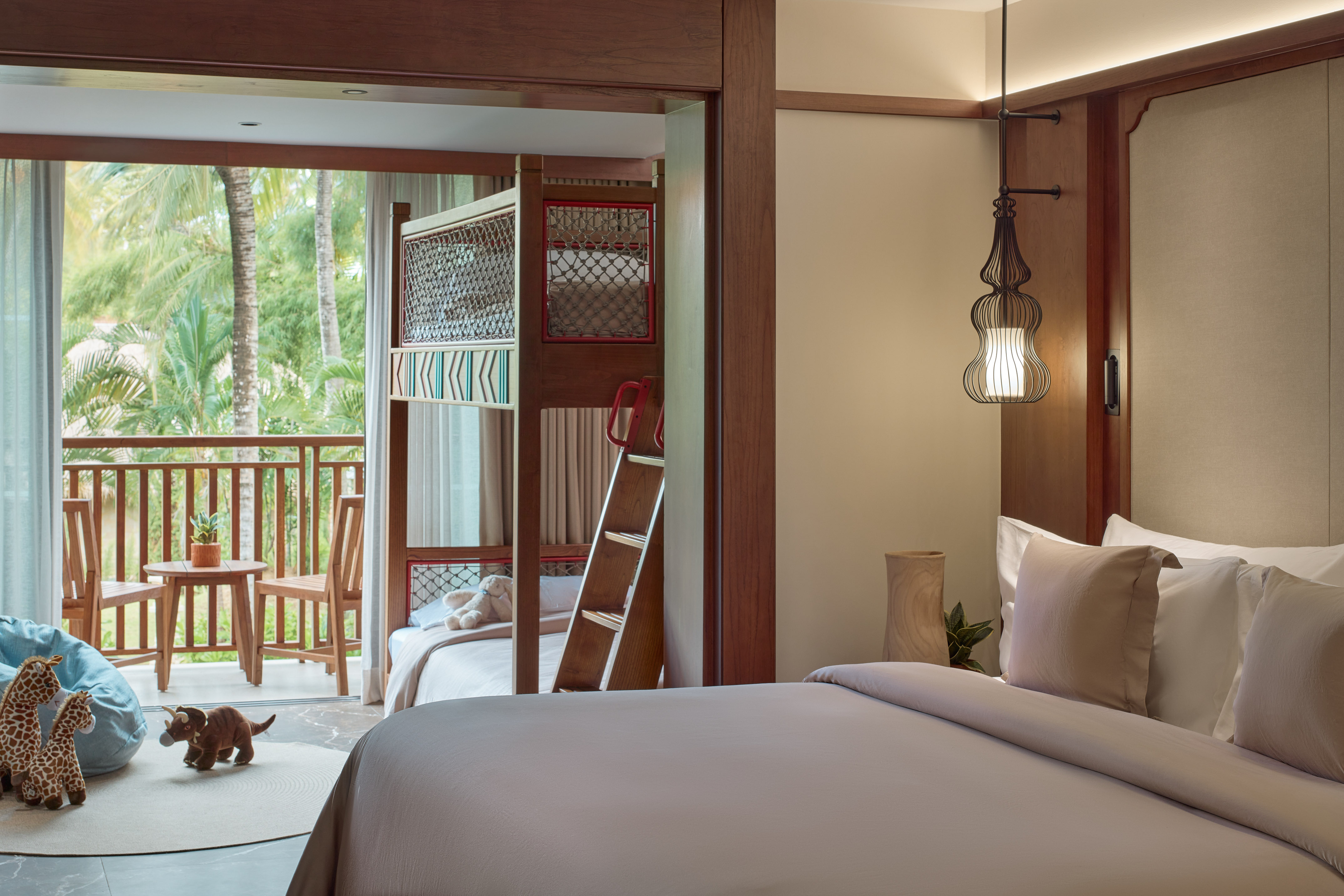 a room with a bed and bunk beds