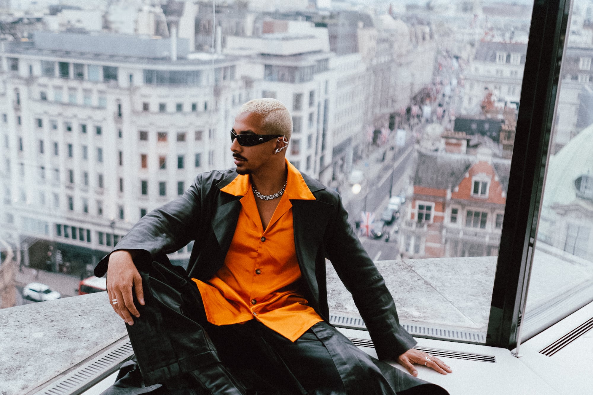 a man sitting on a window ledge