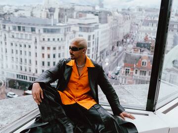 a man sitting on a window ledge