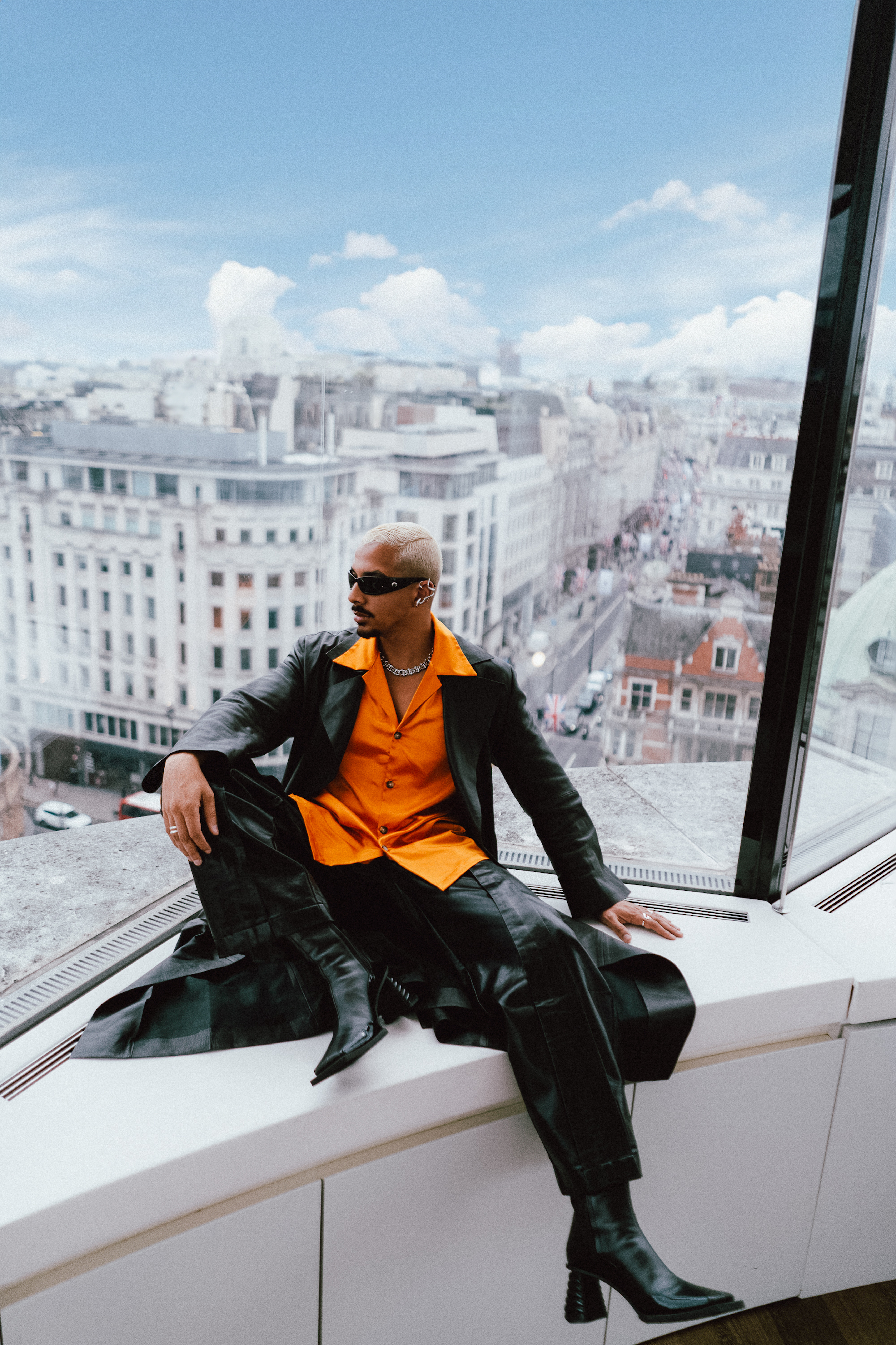 a man sitting on a window ledge