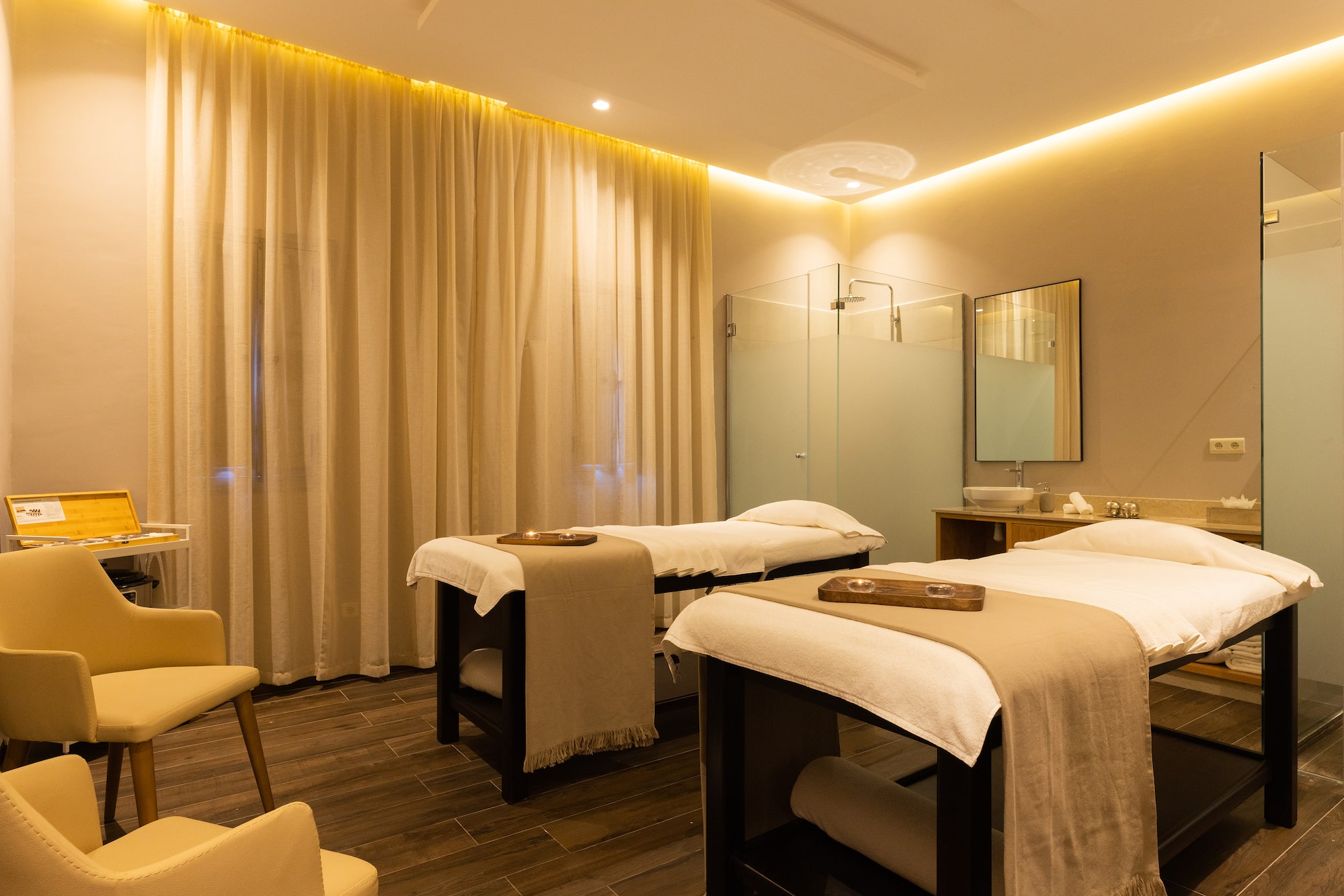 a massage room with beds and a shower