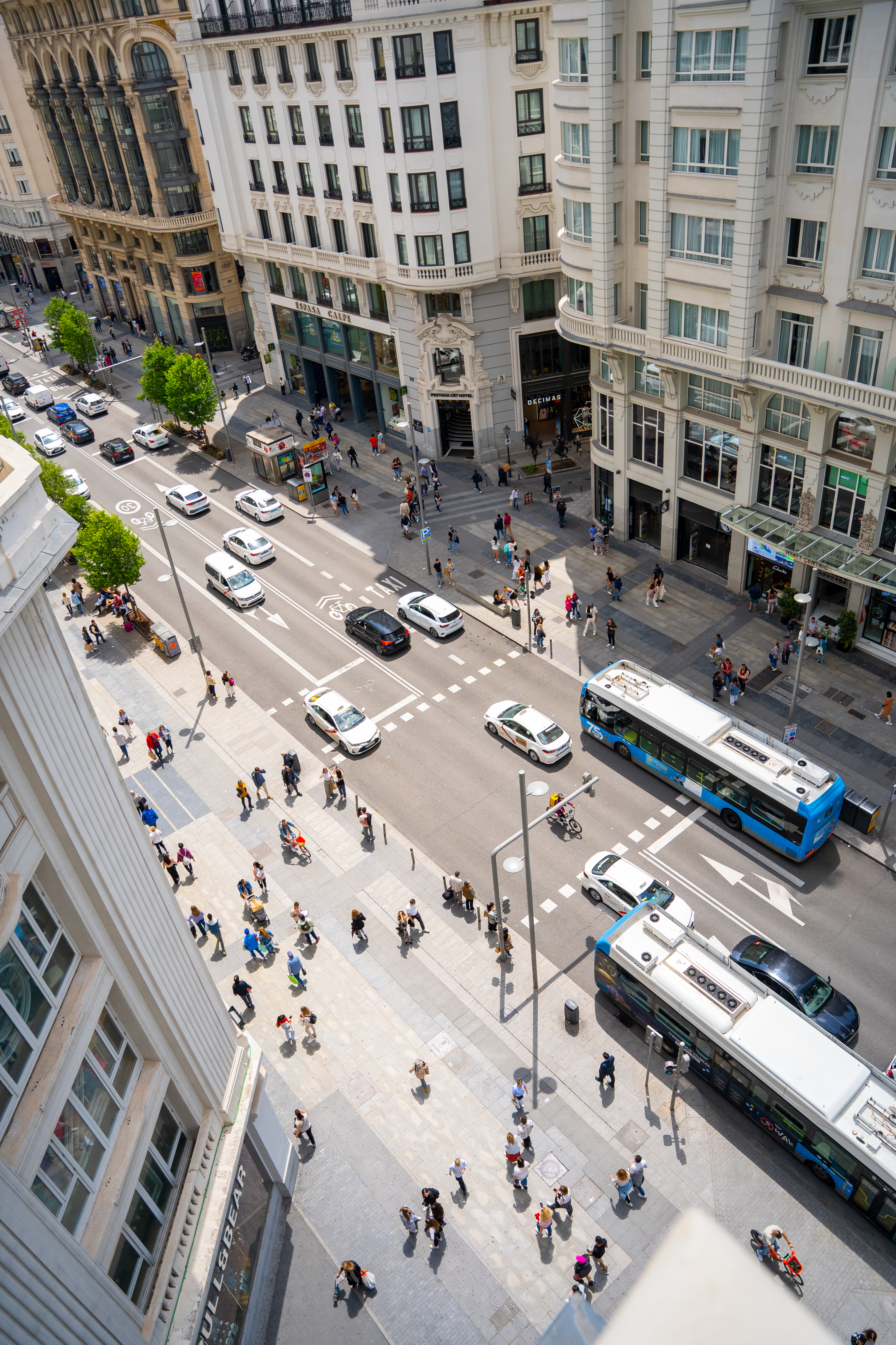 a city street with people and cars