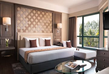 a bedroom with a bed and a glass table