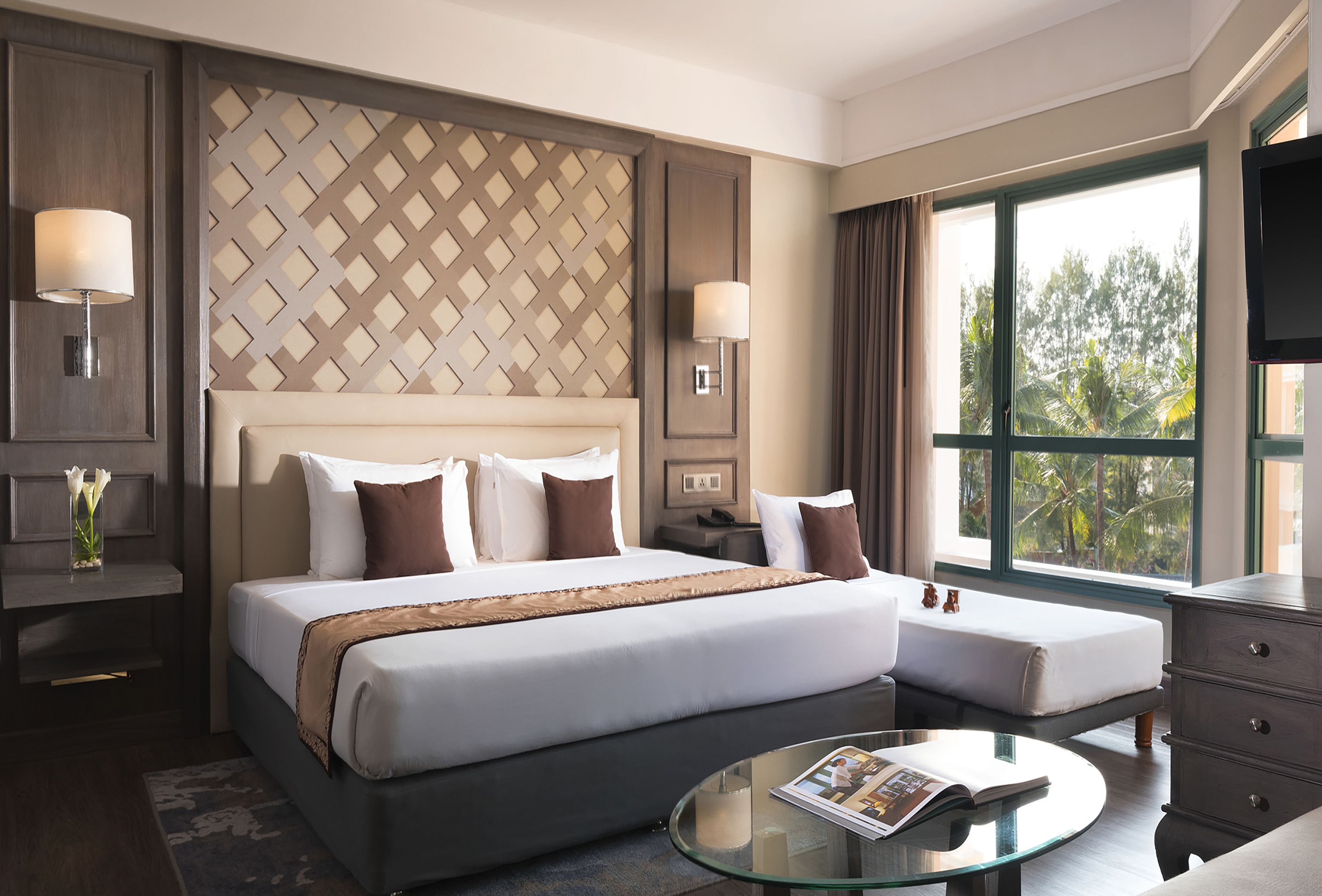 a bedroom with a bed and a glass table