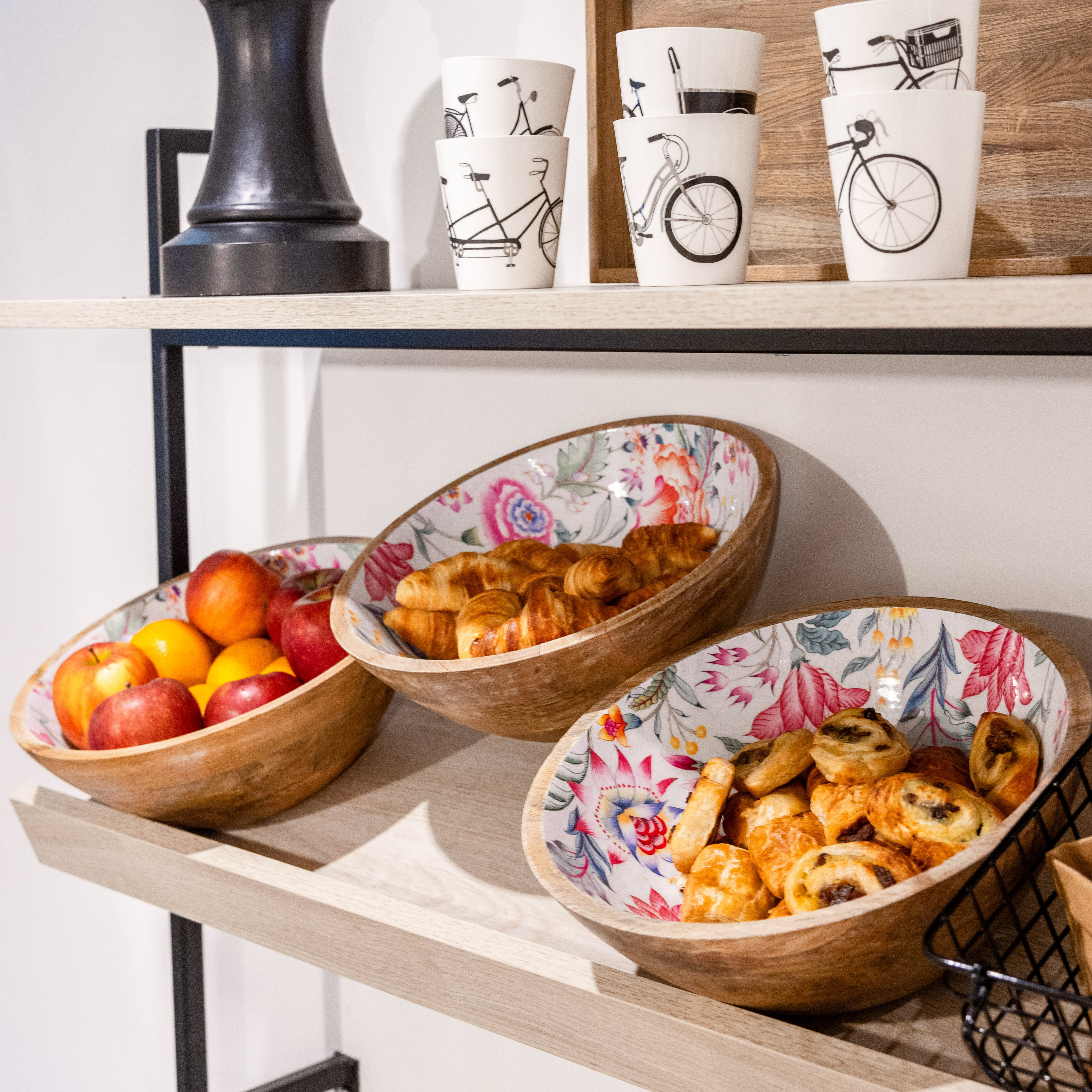a shelf with bowls of food and cups