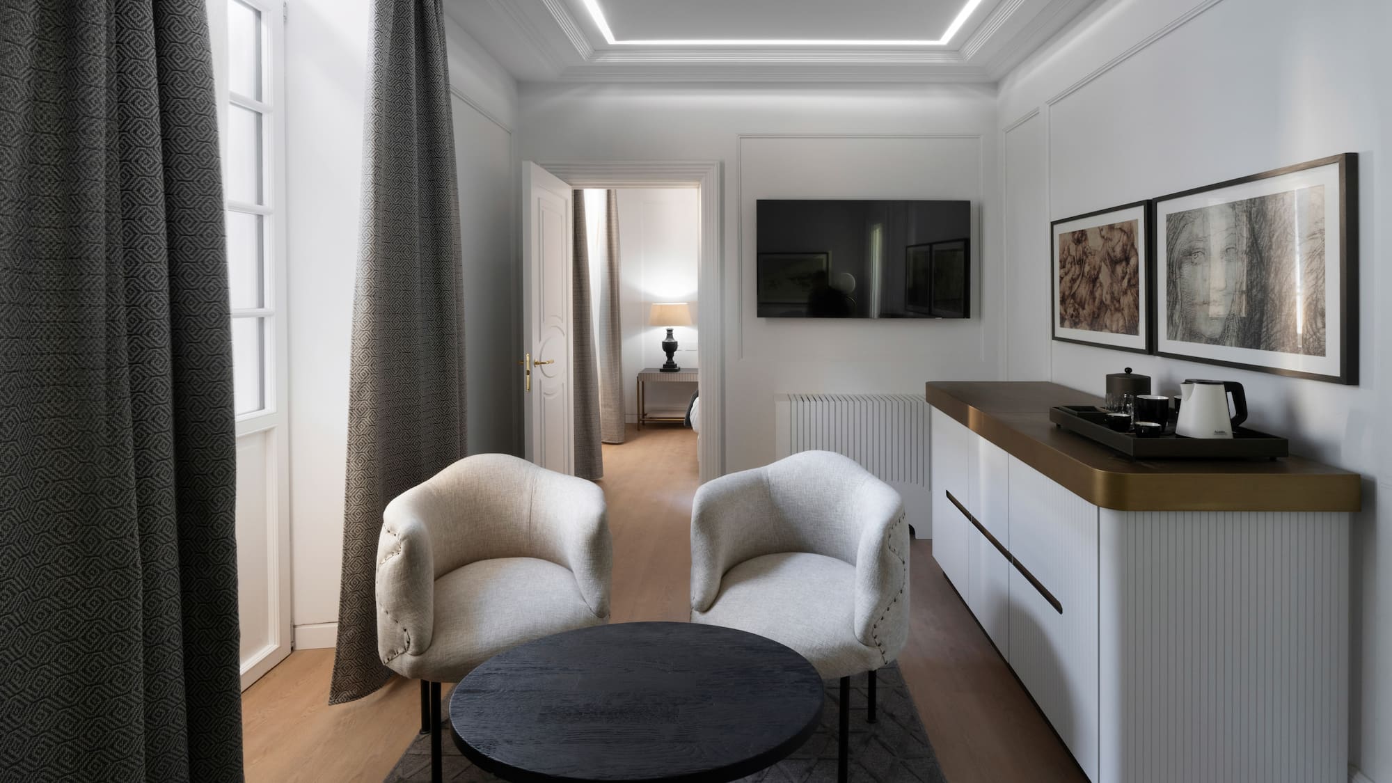 a room with white furniture and a black table