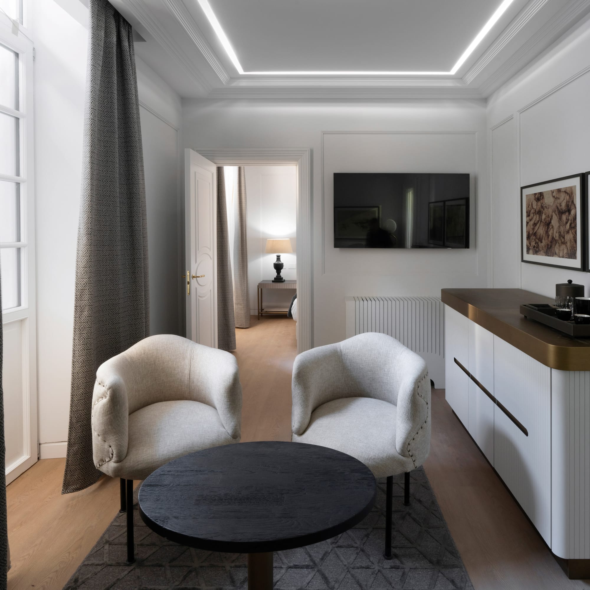 a room with white furniture and a black table