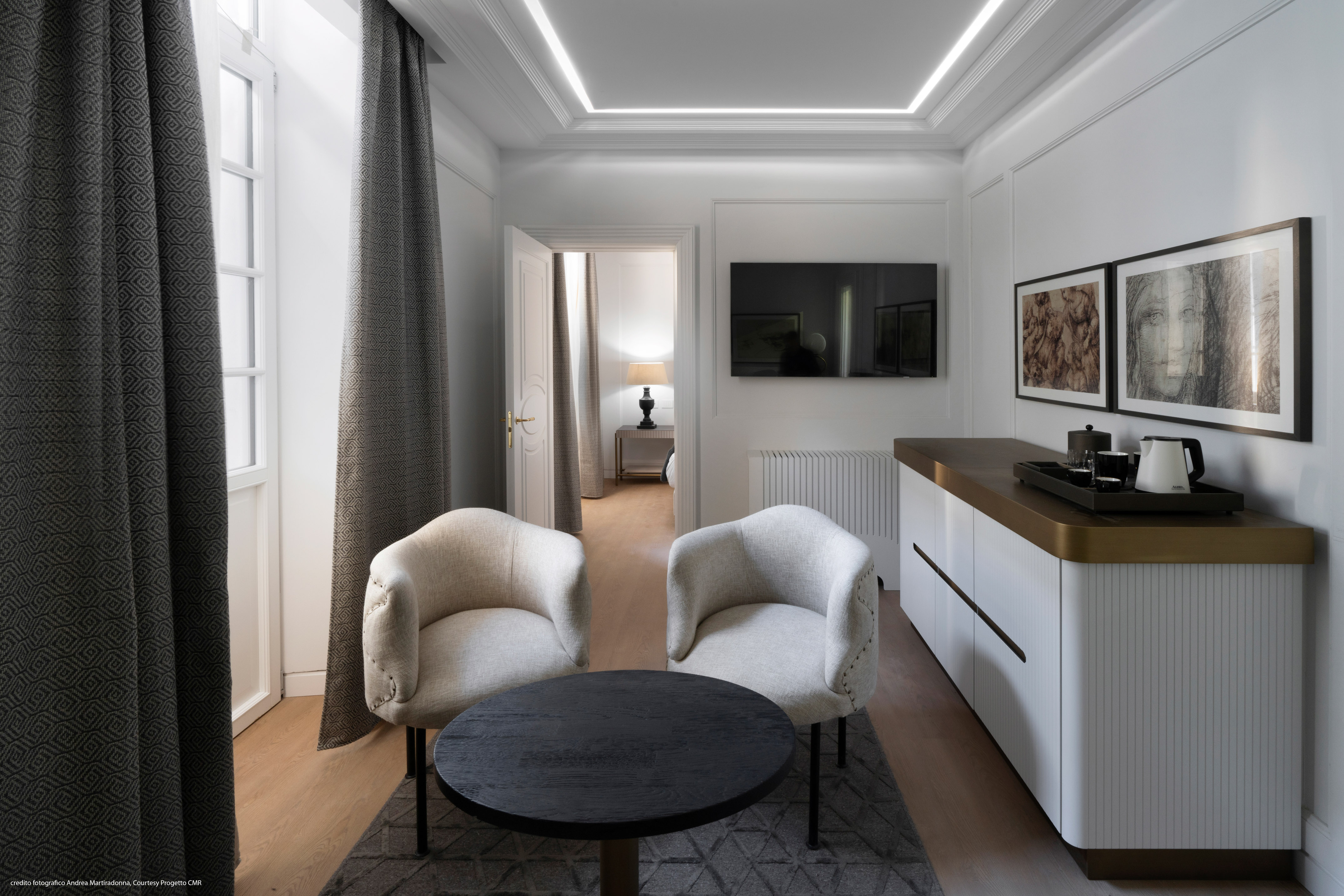 a room with white furniture and a black table