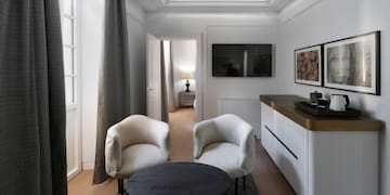 a room with white furniture and a black table