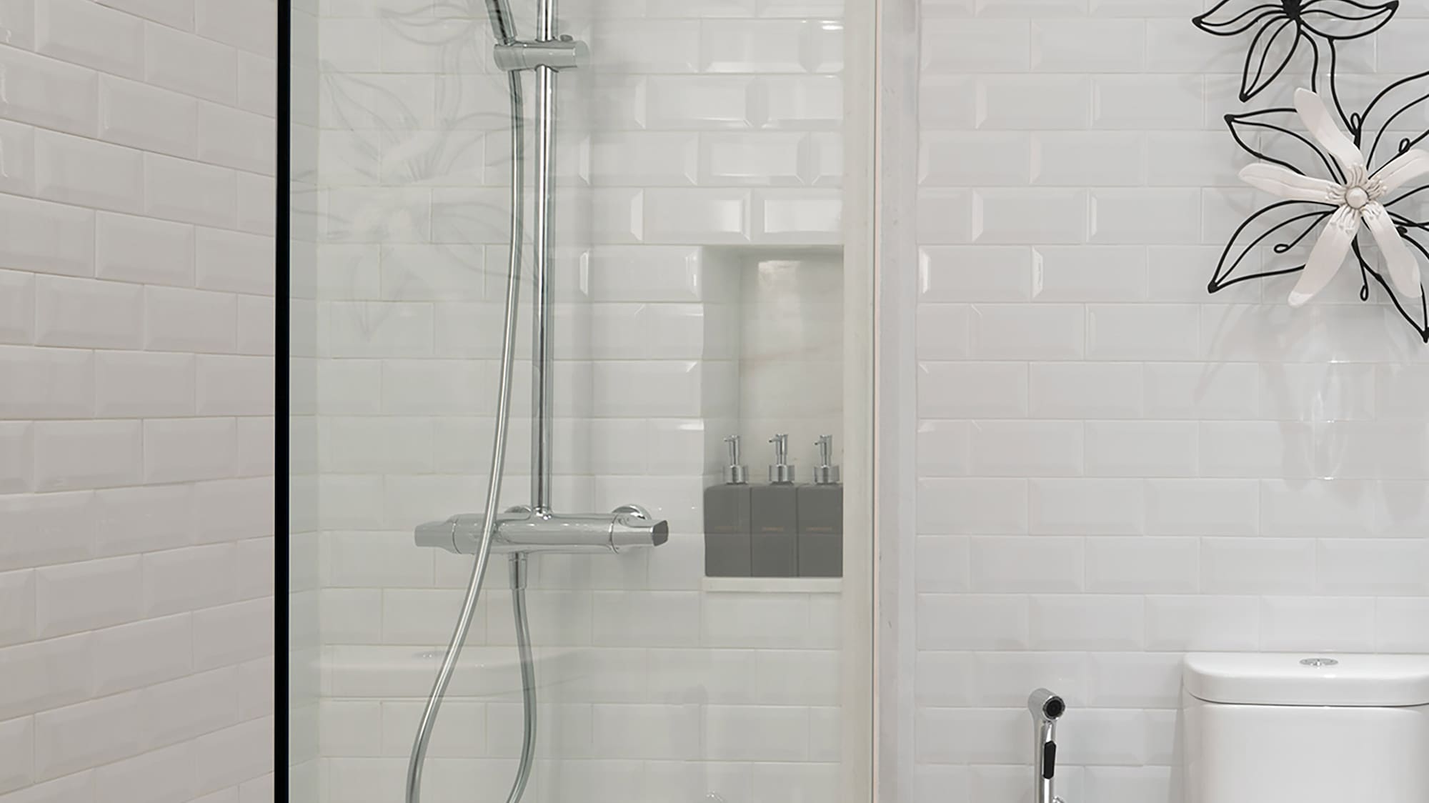 a shower with a toilet and a toilet