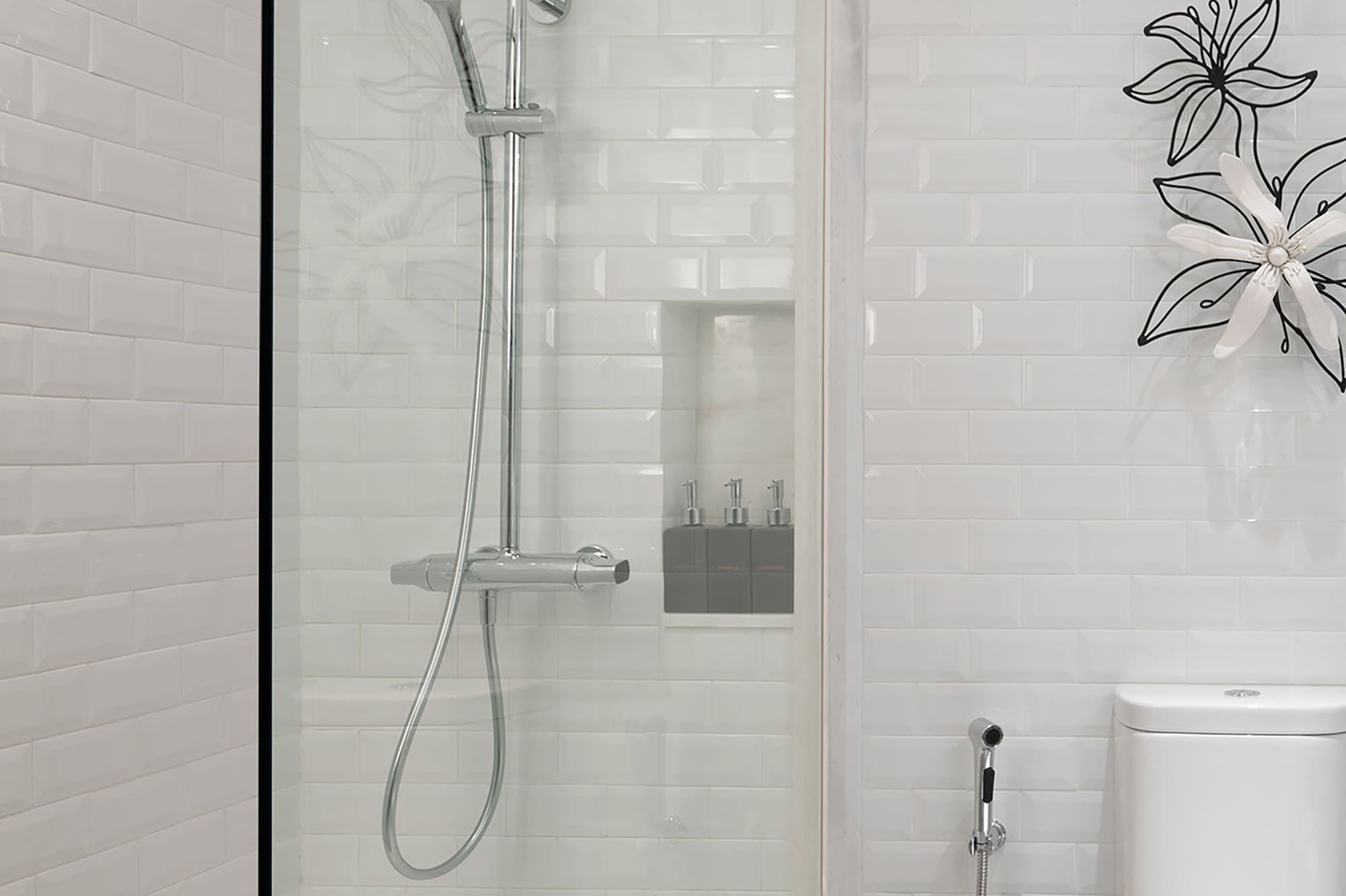 a shower with a toilet and a toilet