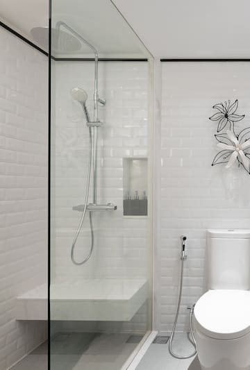 a shower with a toilet and a toilet