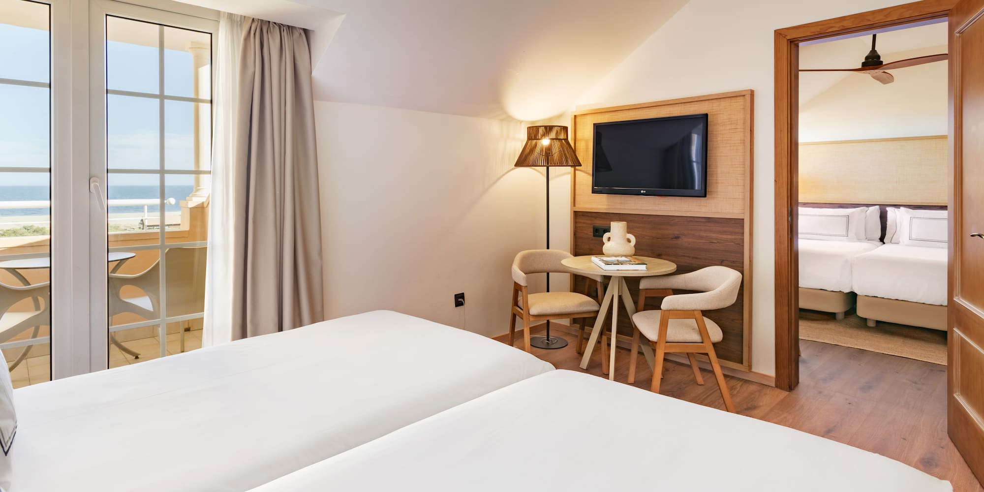 a room with two beds and a television