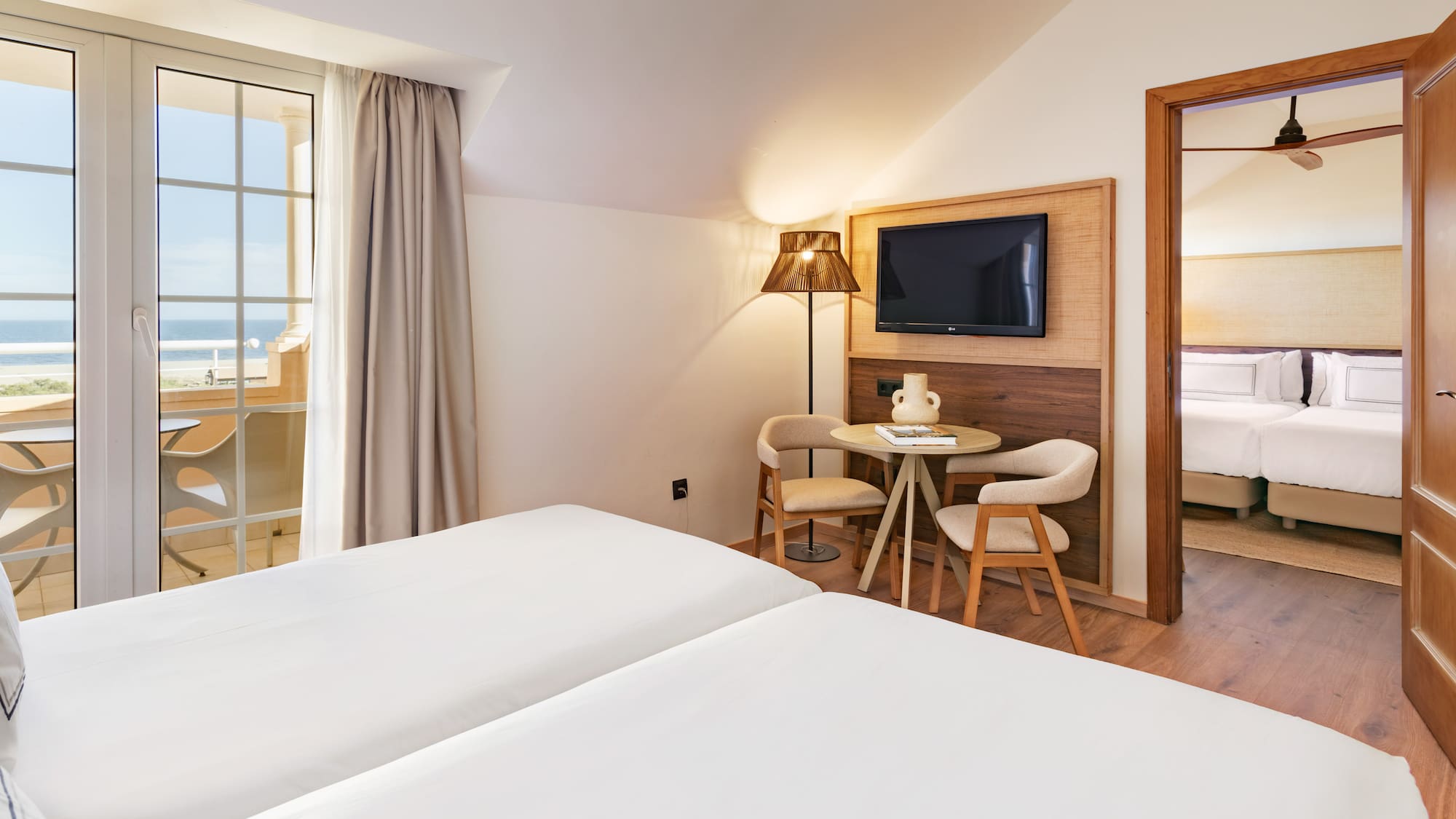 a room with two beds and a television