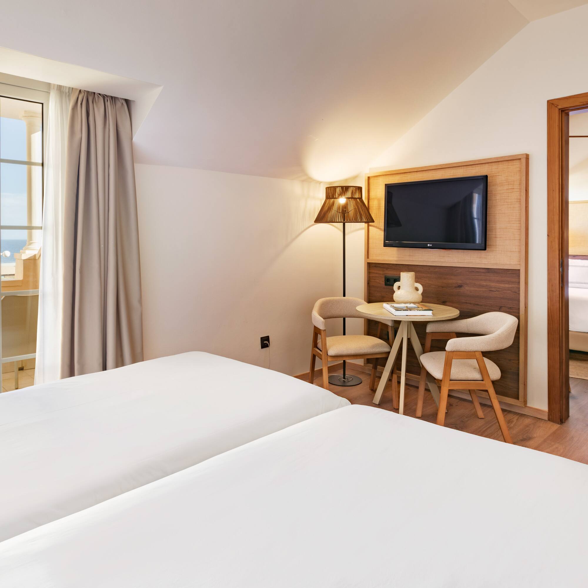 a room with two beds and a television