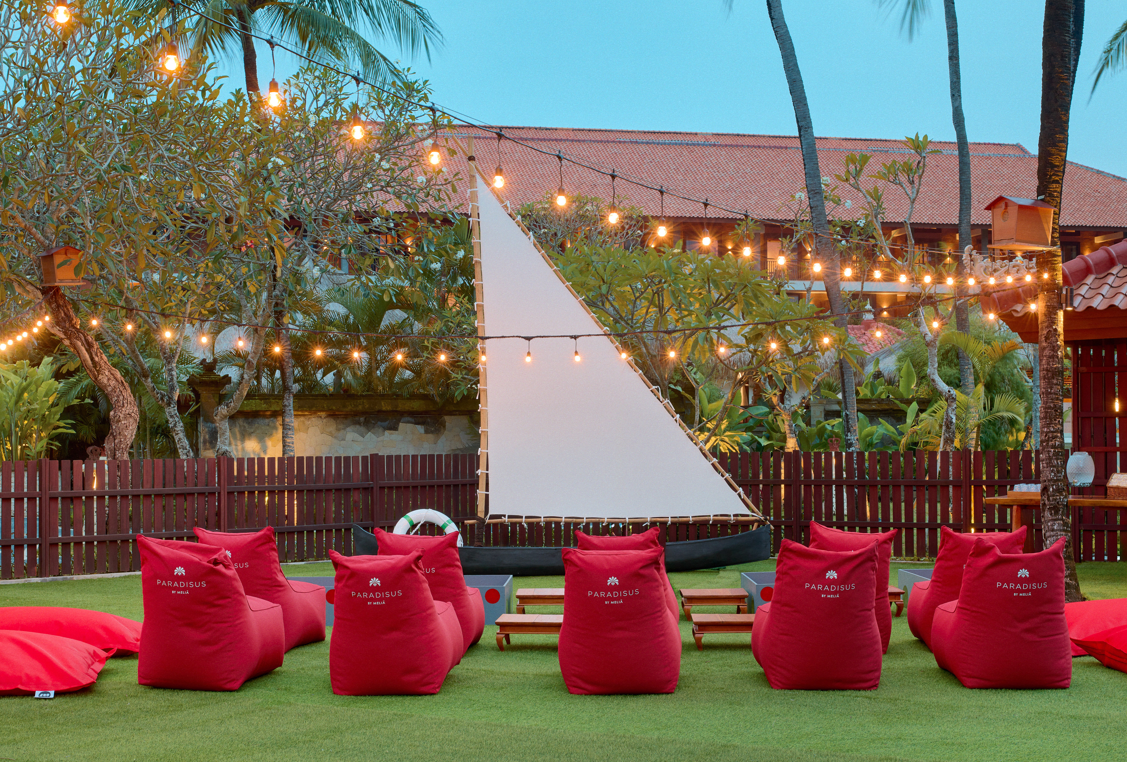 a group of red bean bags in a yard