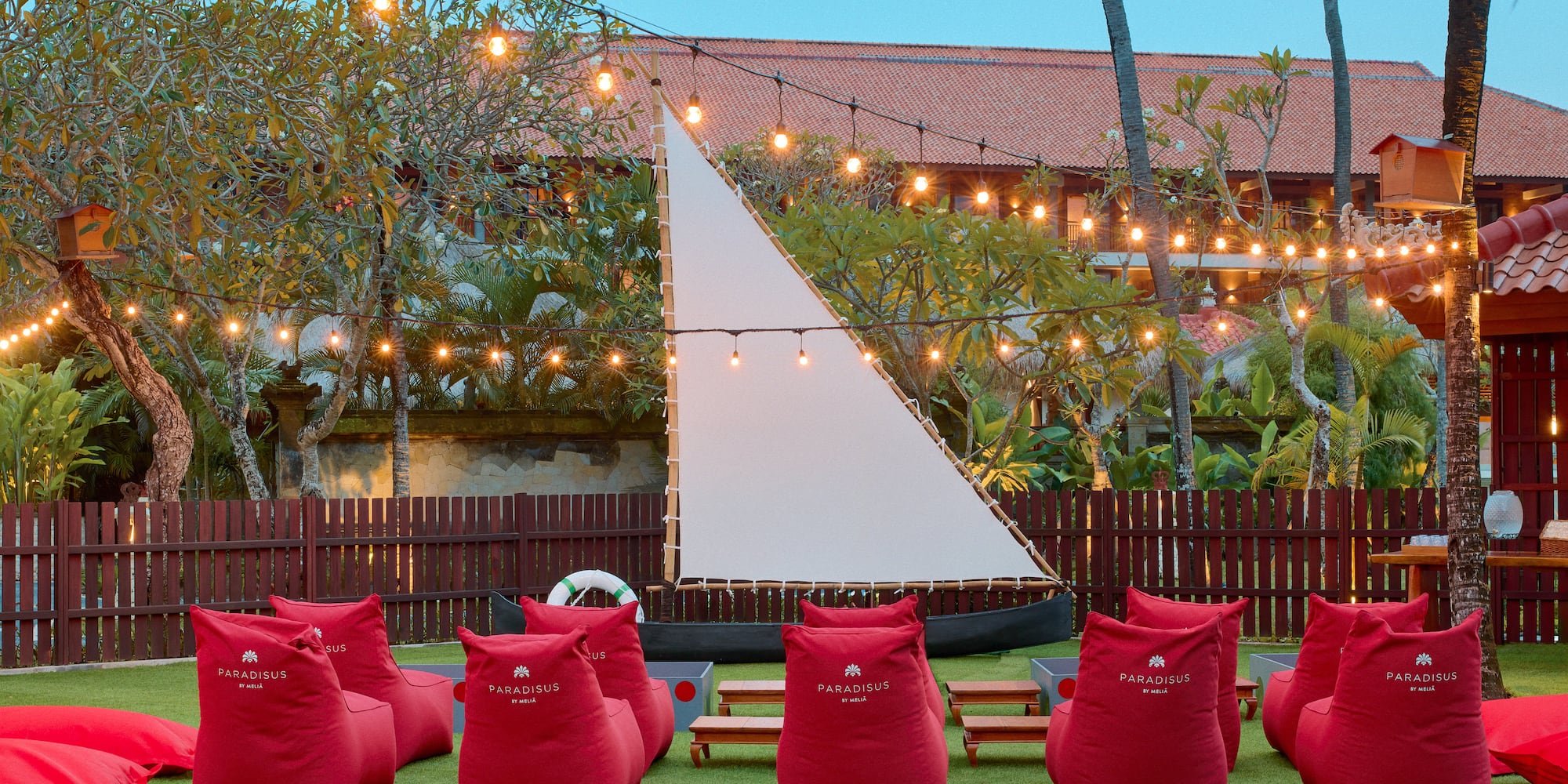 a group of red bean bags in a yard