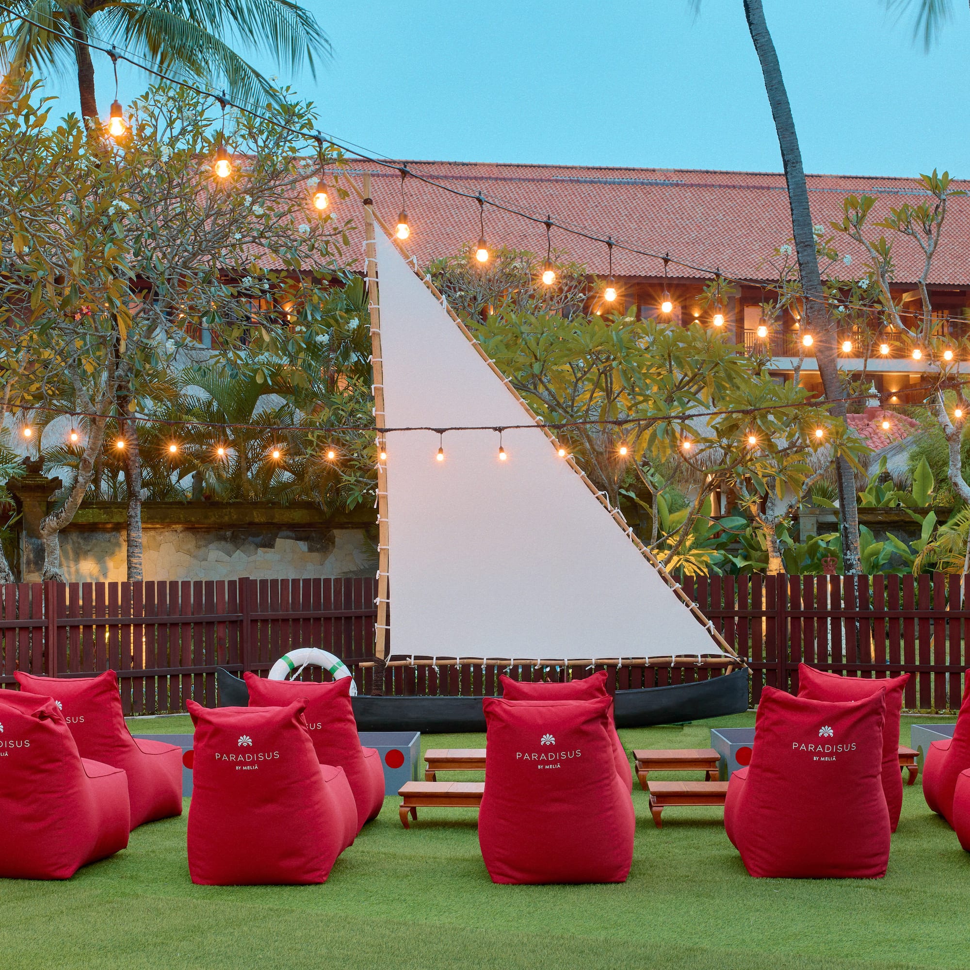 a group of red bean bags in a yard