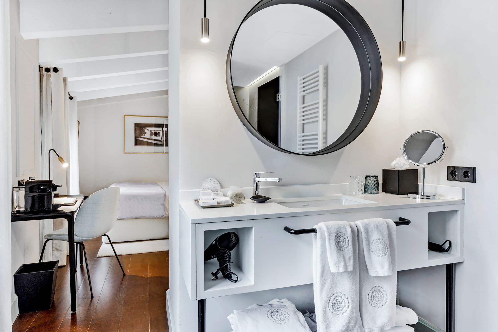 a bathroom with a round mirror