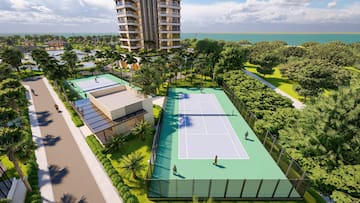 a tennis court with trees and buildings in the background