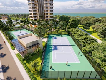 a tennis court with trees and buildings in the background