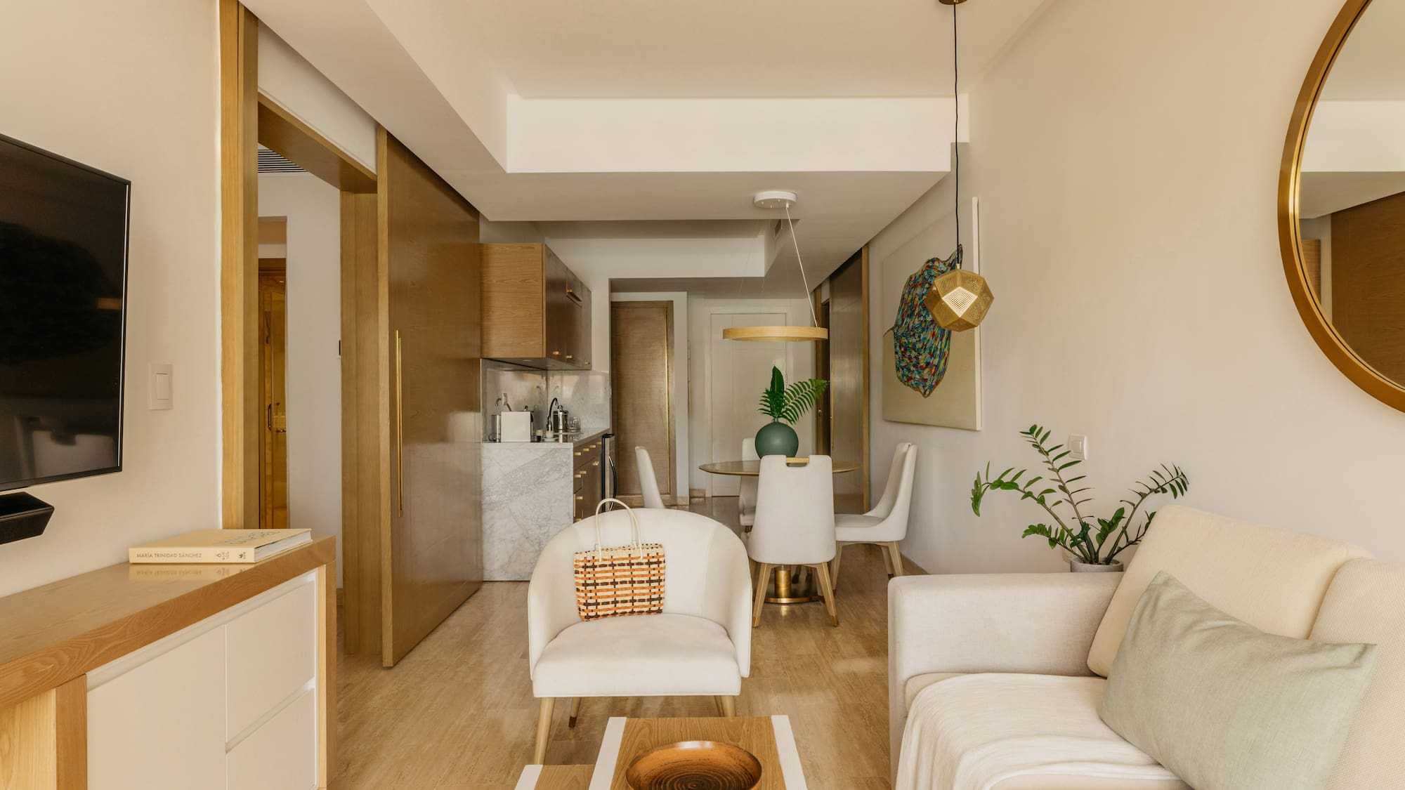 Modern neutral studio apartment living room, dining, kitchenette.