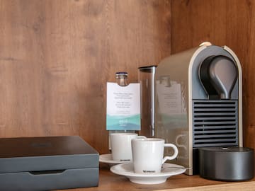 a coffee machine and coffee cups on a table