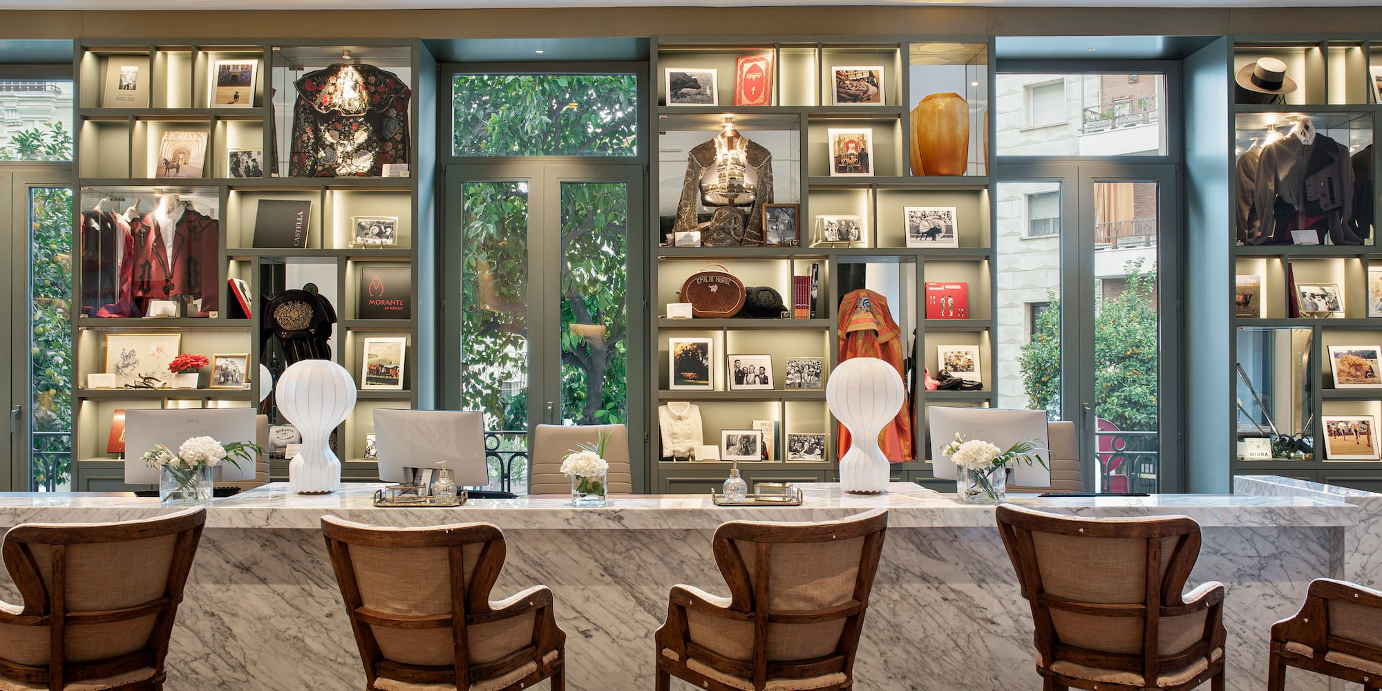 a marble counter with chairs and a marble table with a marble counter