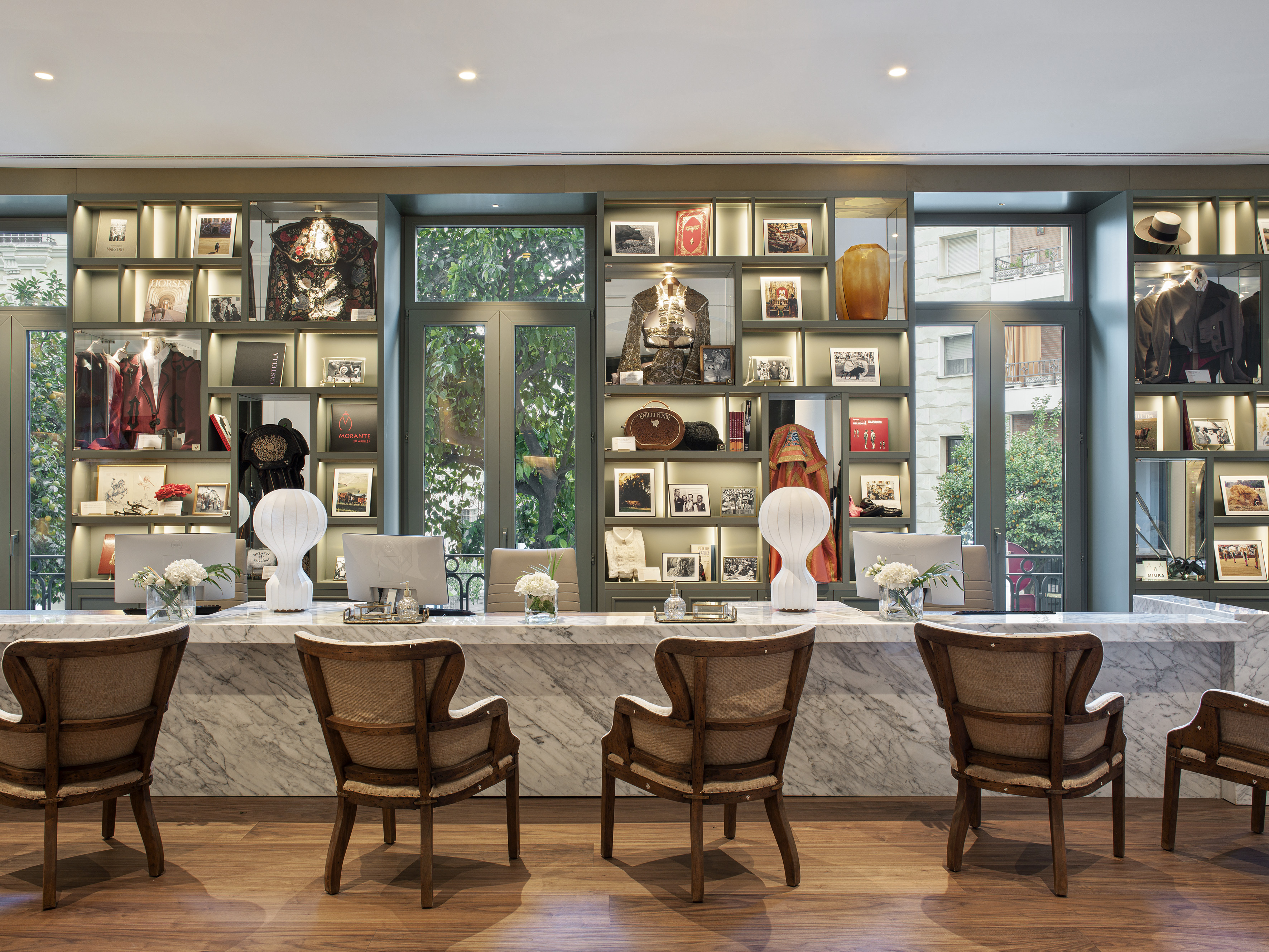 Marble reception desk with ornate jackets display and books.