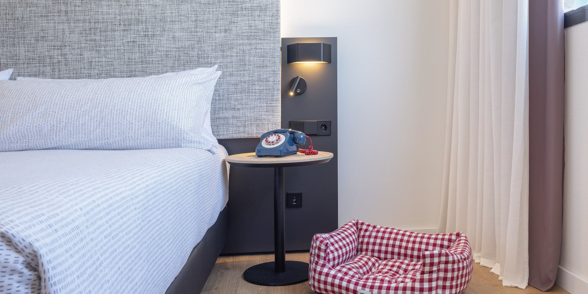 a dog bed and bowls on the floor