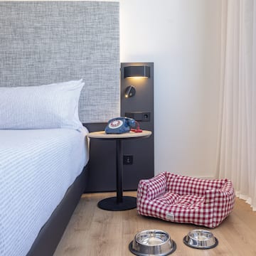 a dog bed and bowls on the floor