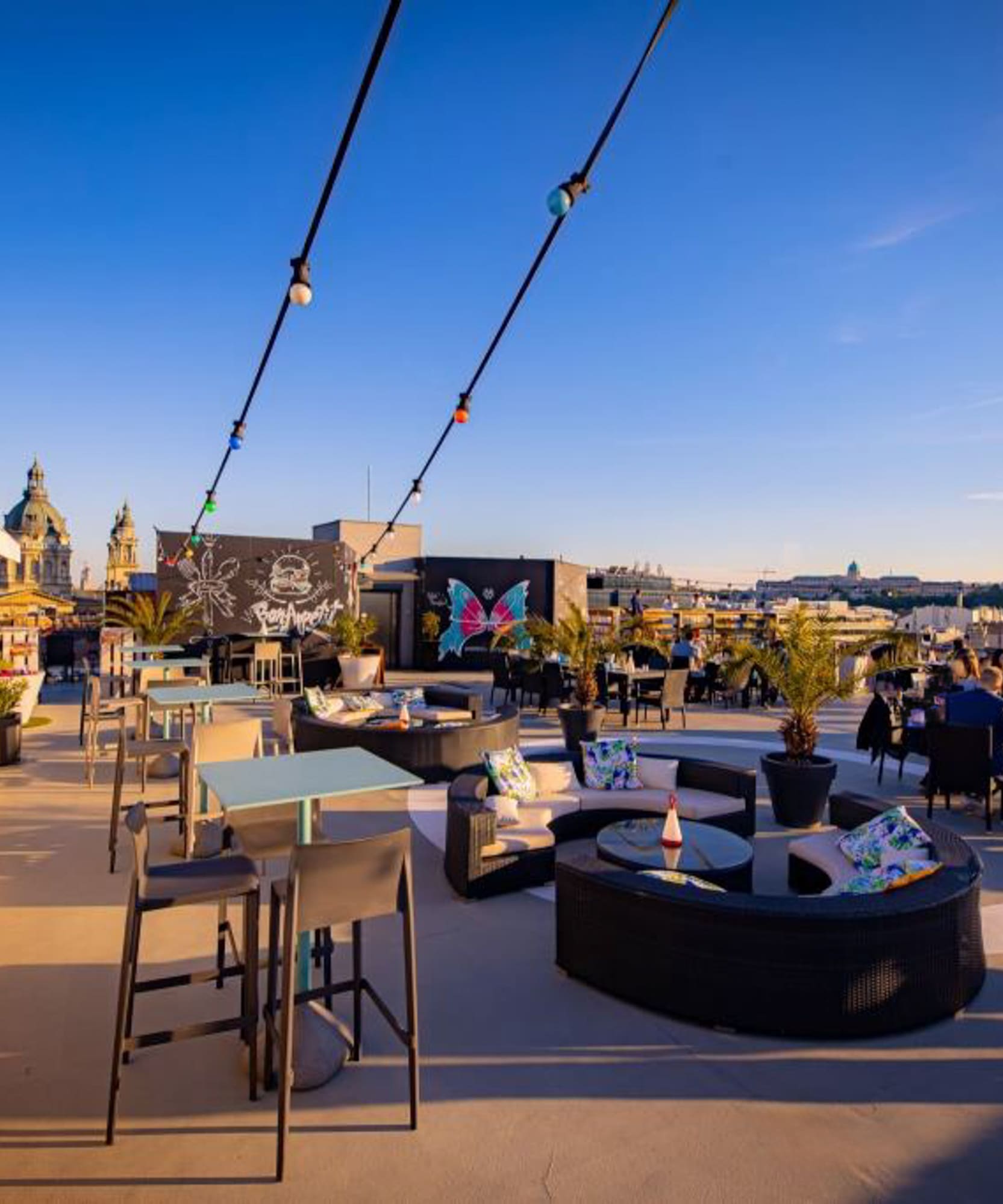 a rooftop patio with tables and chairs