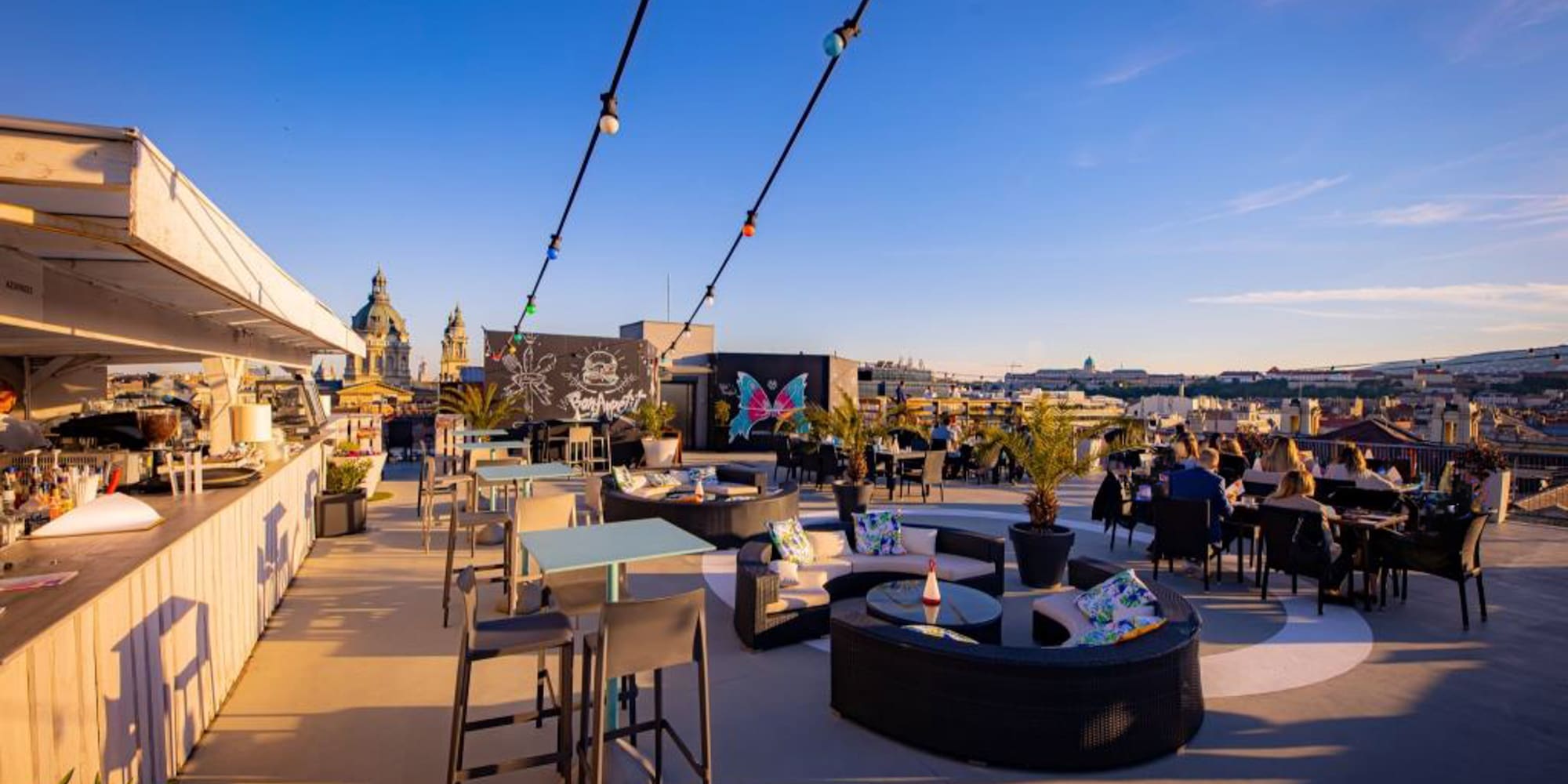 a rooftop patio with tables and chairs