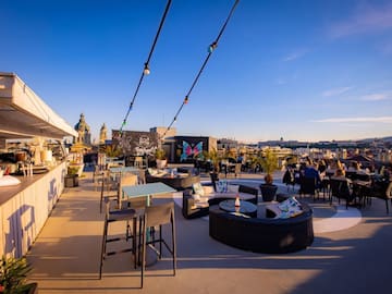 a rooftop patio with tables and chairs