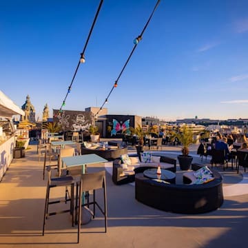 a rooftop patio with tables and chairs