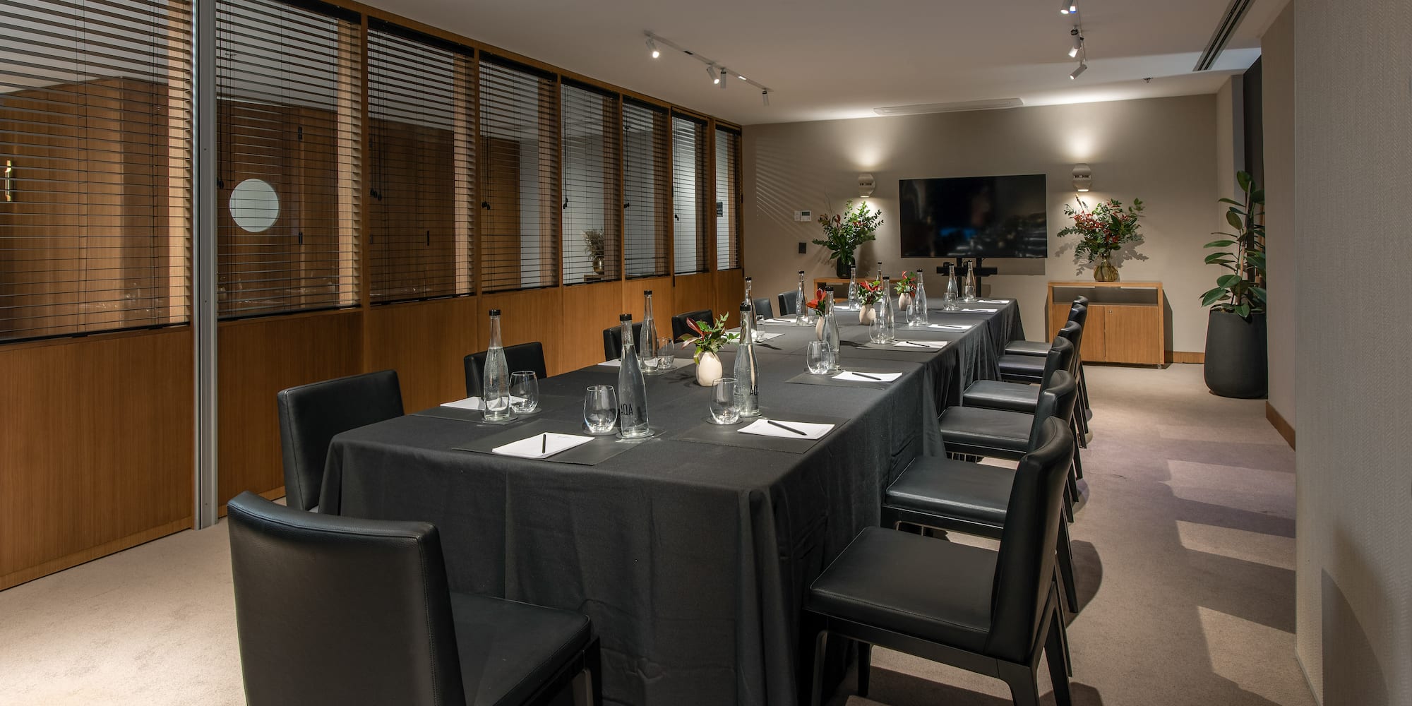 a long table with black cloths and chairs