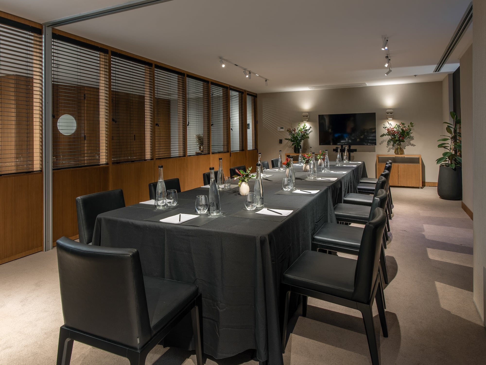 a long table with black cloths and chairs