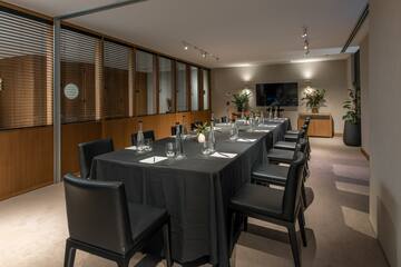 a long table with black cloths and chairs