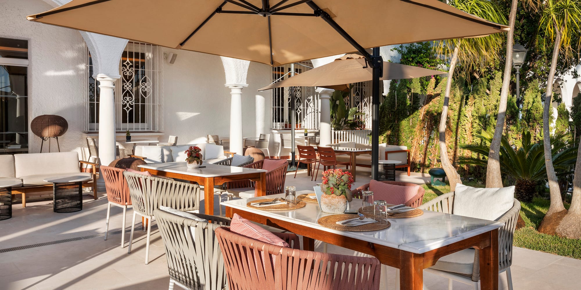 a table and chairs under an umbrella