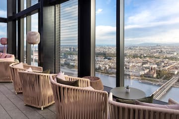 a room with a view of a city and a river