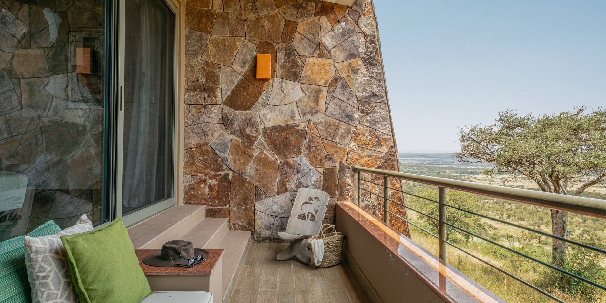 a balcony with a chair and a hat