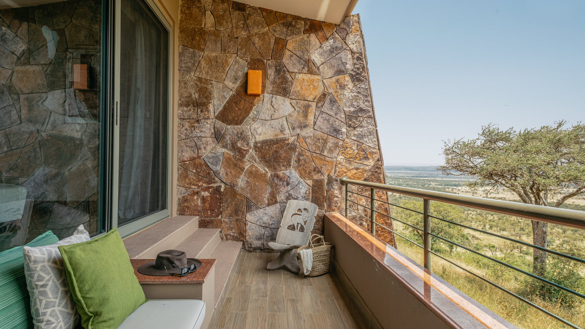 a balcony with a chair and a hat