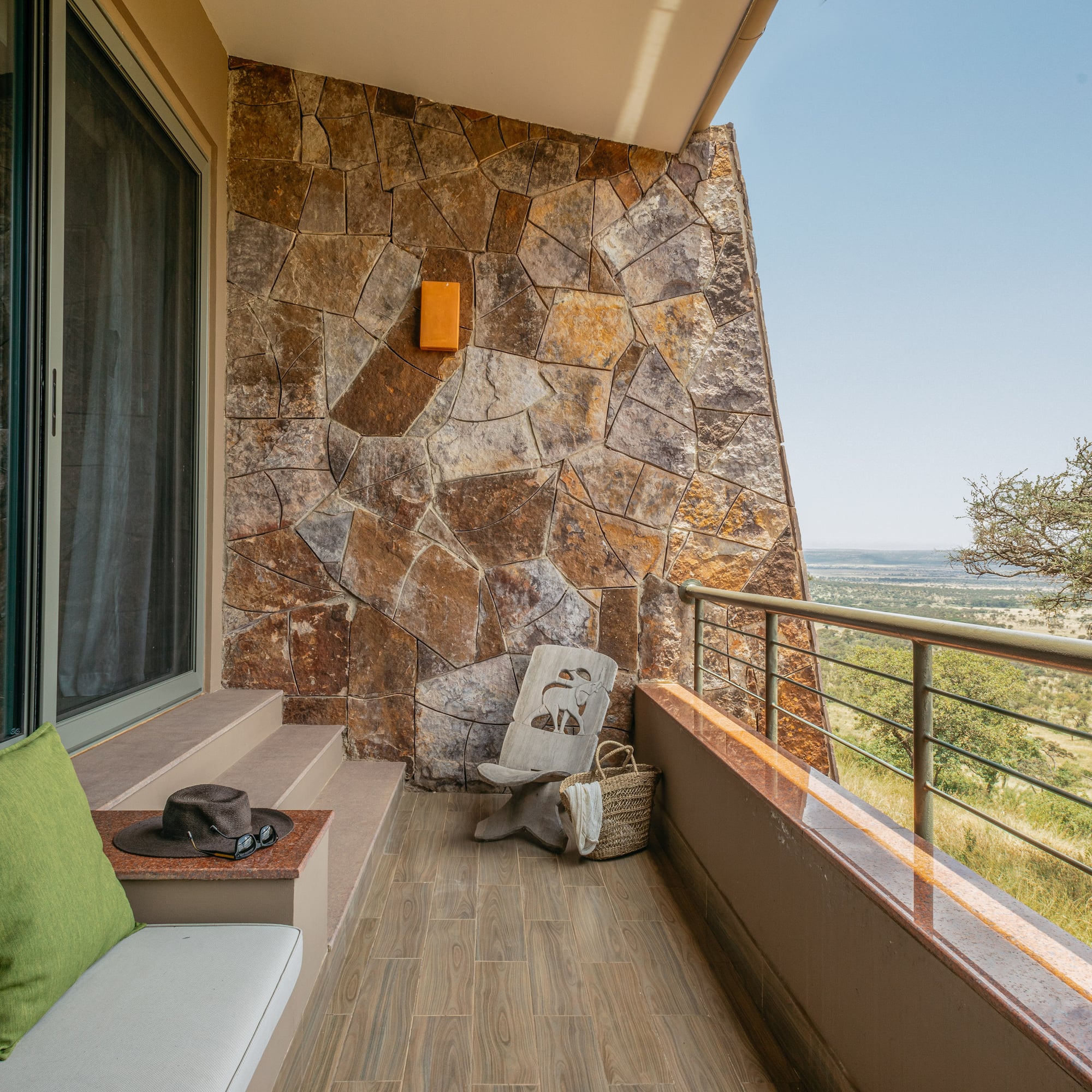 a balcony with a chair and a hat