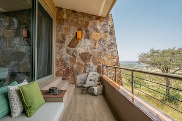 a balcony with a chair and a hat