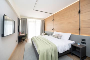 a bedroom with a bed and a desk