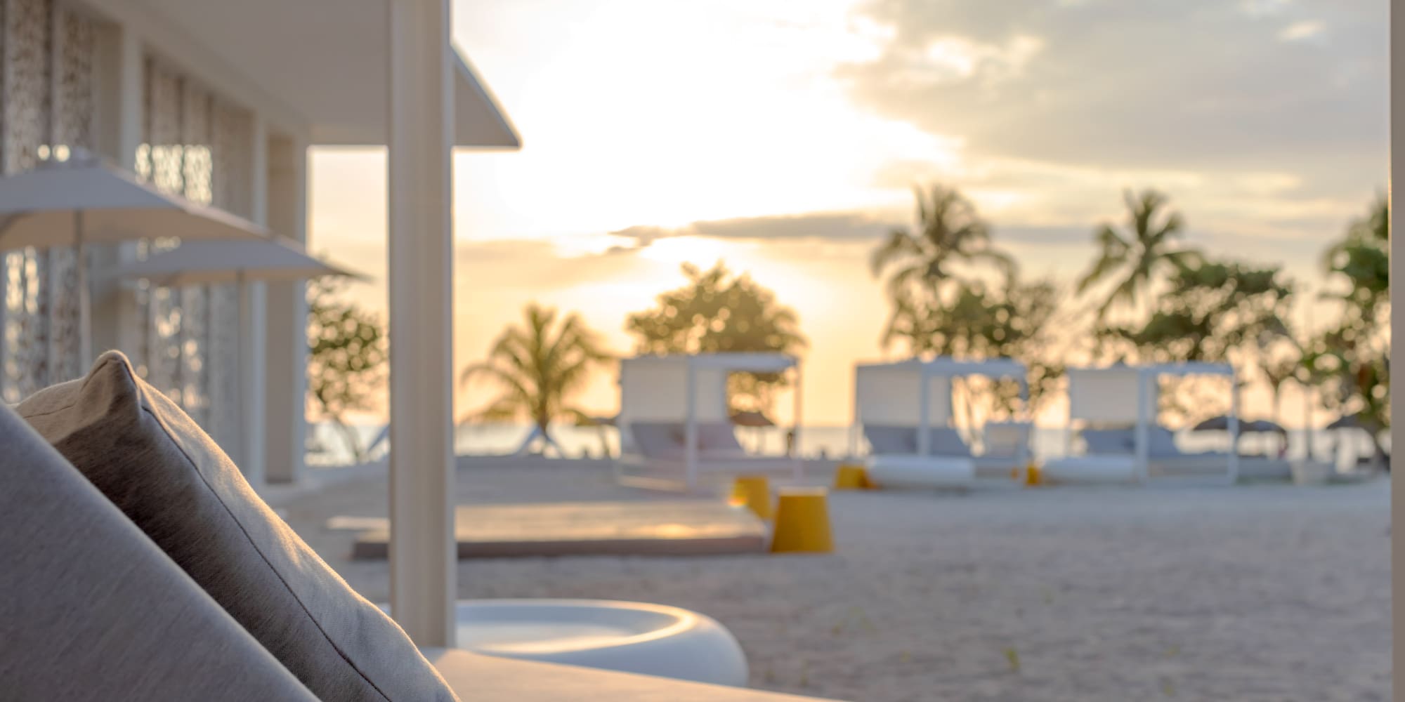 a beach with a couch and chairs