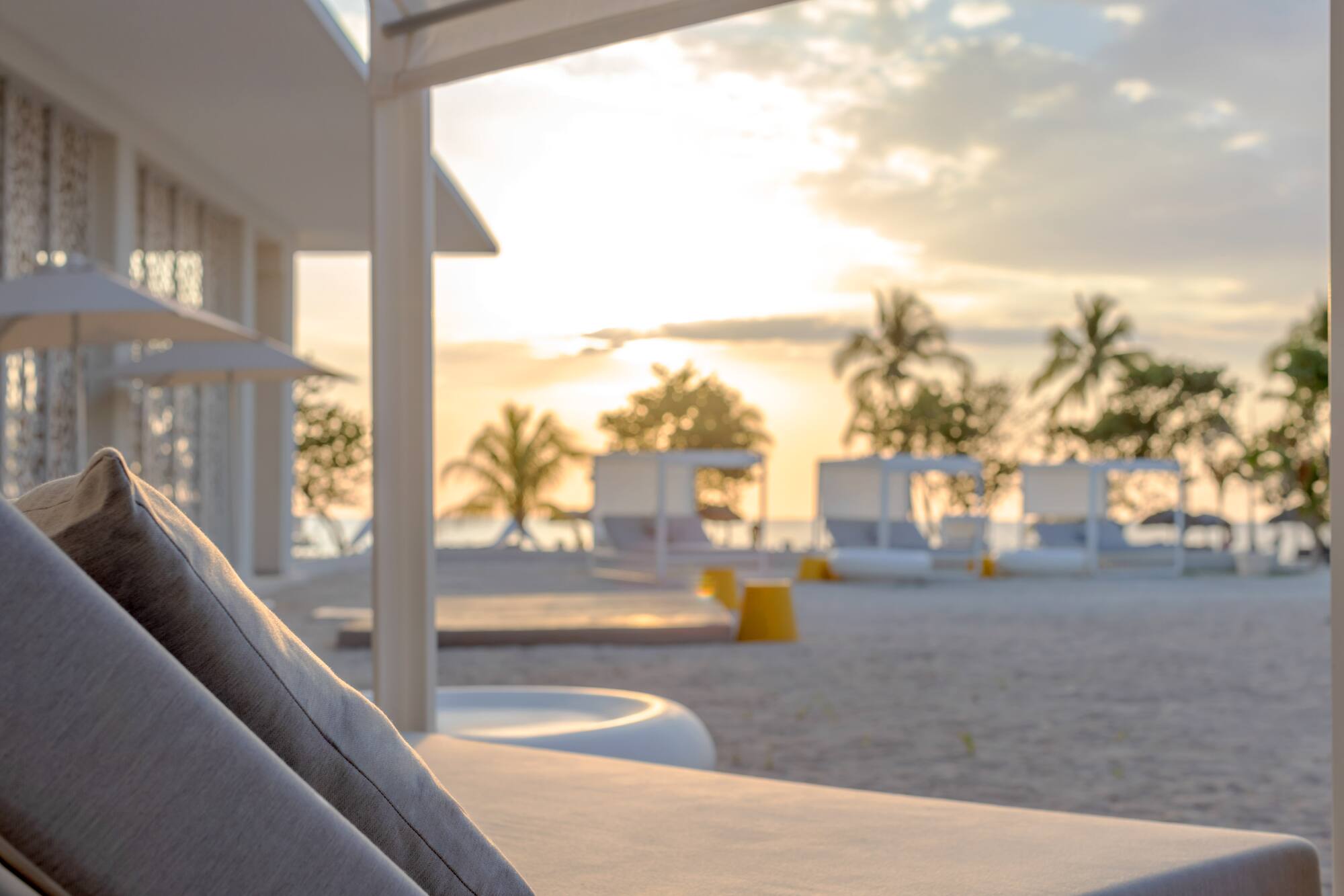 a beach with a couch and chairs