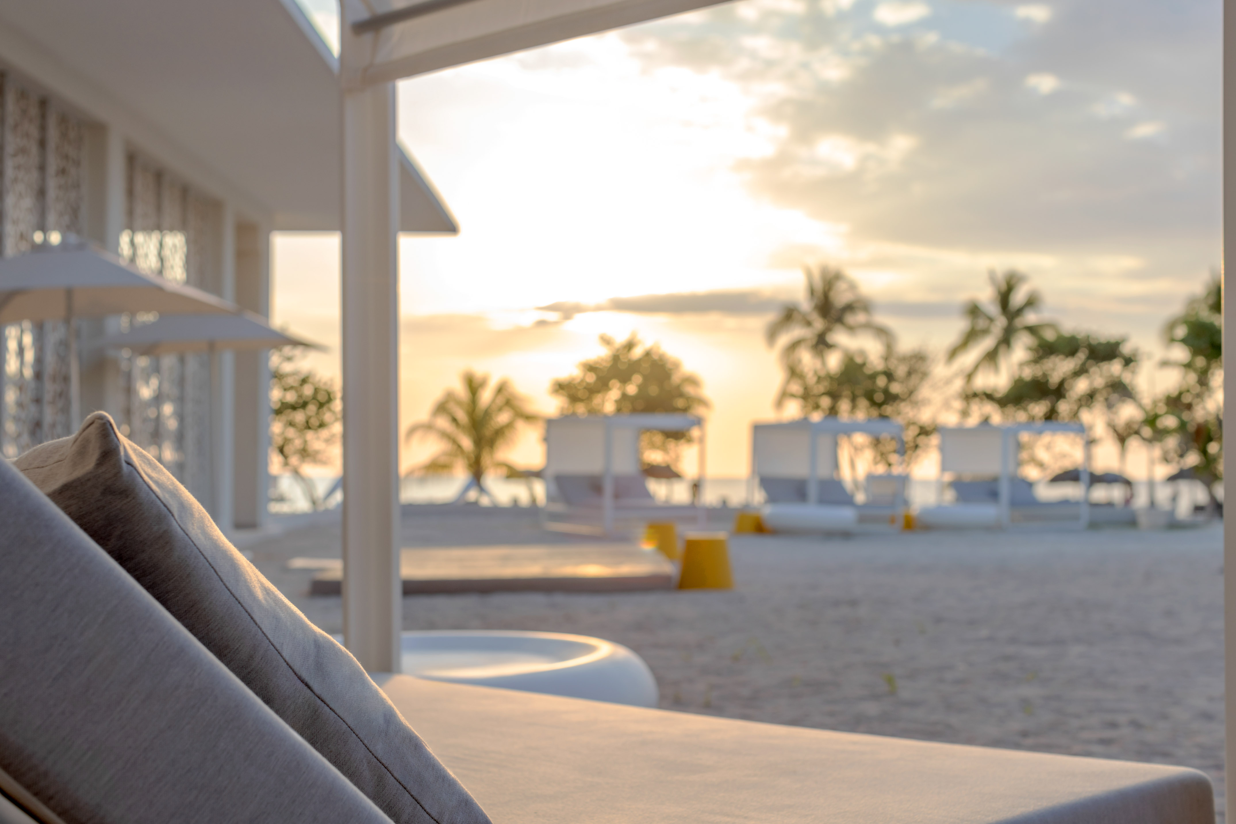 a beach with a couch and chairs